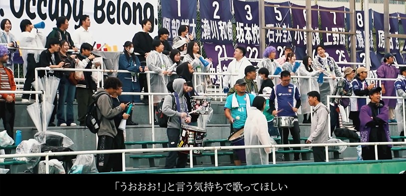 スタジアムでアンセムを歌うサポーター